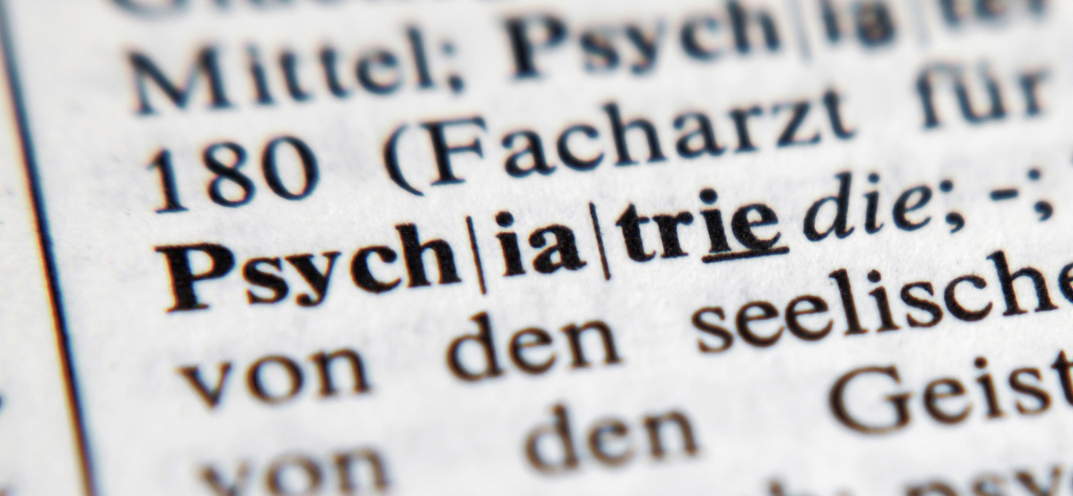 Nahaufnahme eines Wörterbucheintrags, in der Bildmitte steht "Psychiatrie" in fetten Buchstaben